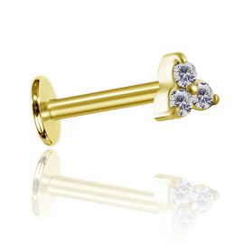 Golden labret piercing with three crystals